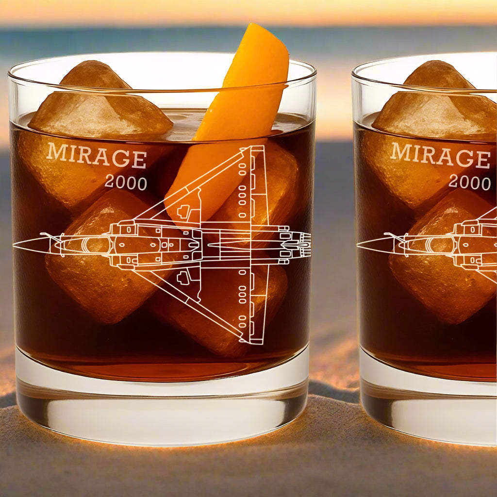 Two glasses of 'Mirage 2000'-themed cocktails with ice and an orange slice on a white background.
