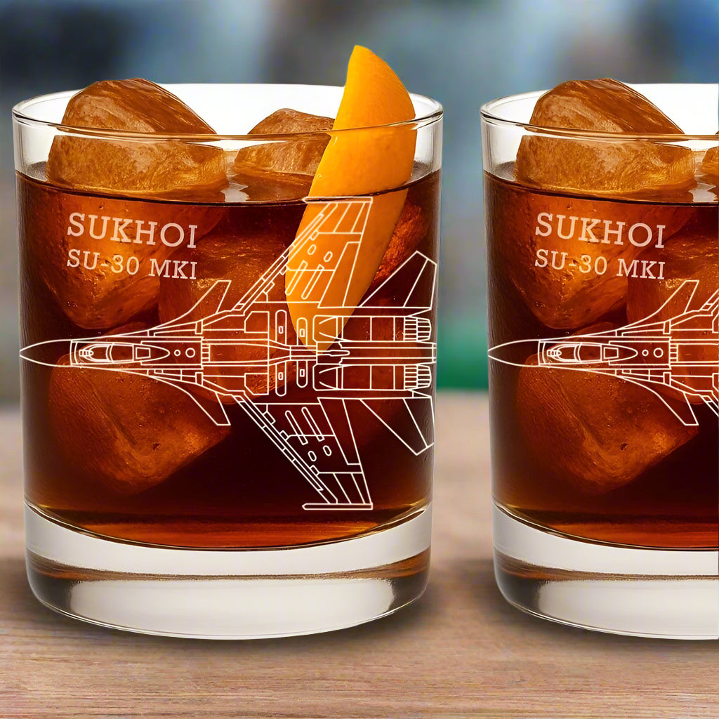 Two glasses of a drink with ice cubes and an orange slice, featuring the Sukhoi SU-30 MKI design.