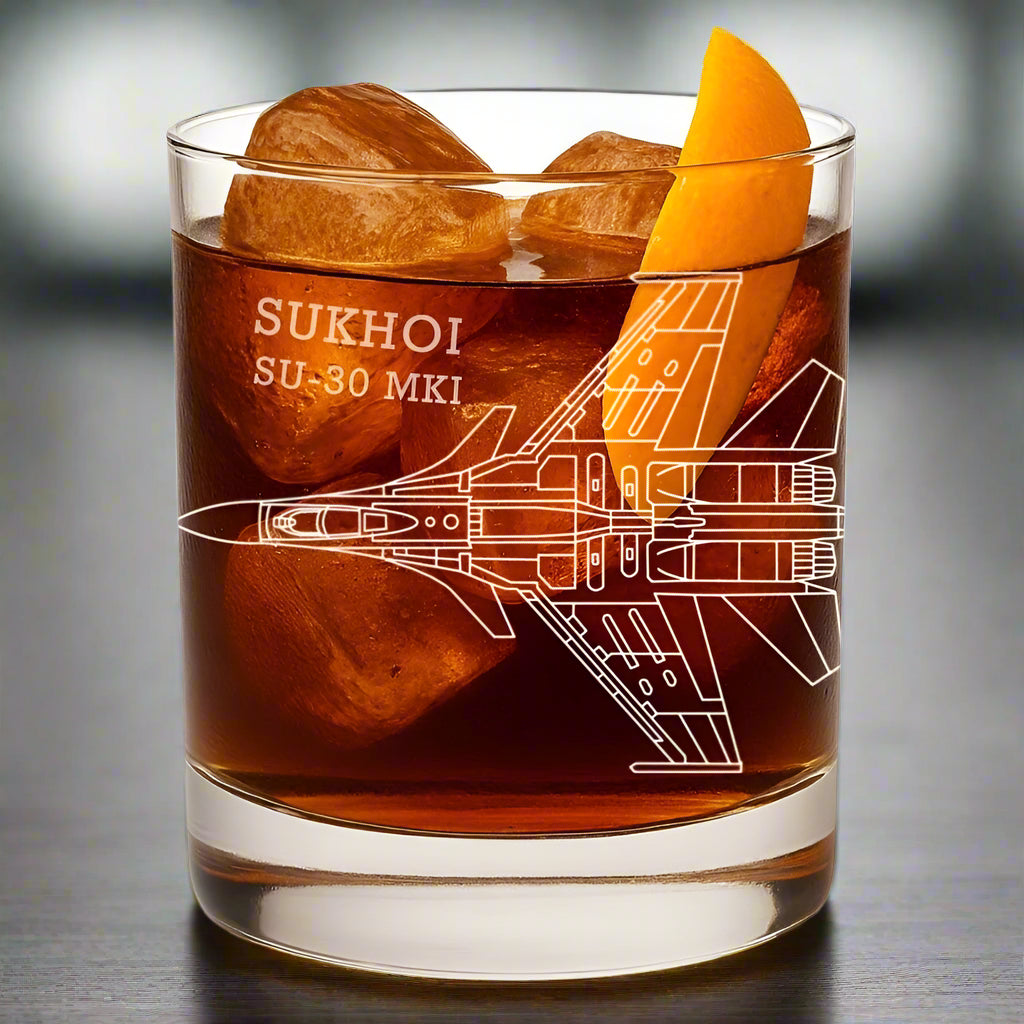 Glass with a Sukhoi SU-30 MKI design, filled with a bourbon cocktail and ice cubes.
