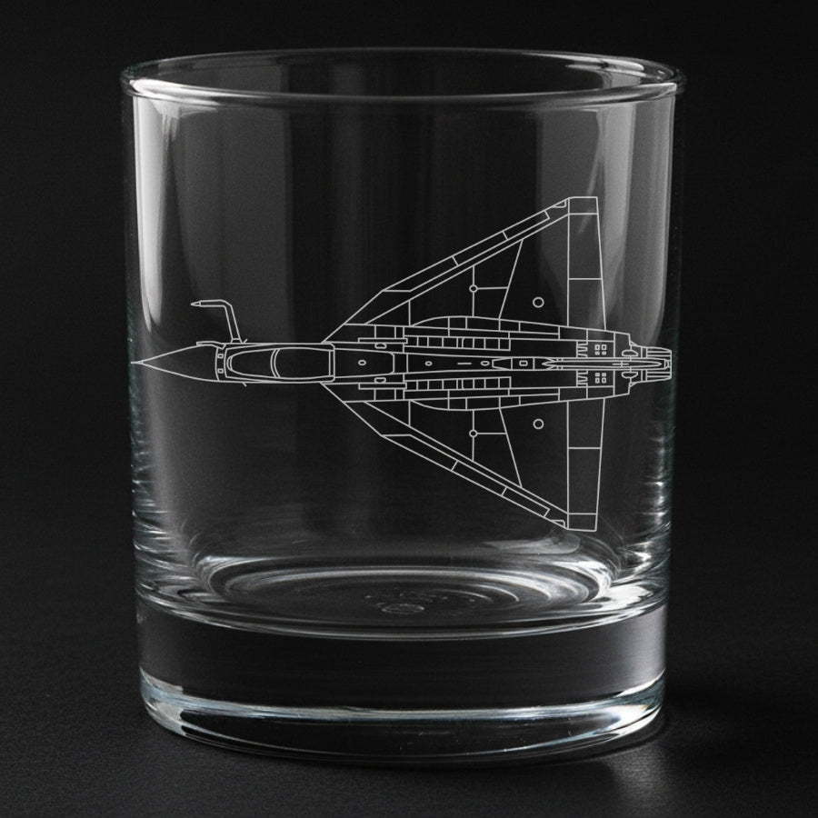 Clear glass tumbler with a Precision engraved tejas airplane design on a black background