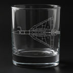 Clear glass tumbler with a Precision engraved tejas airplane design on a black background
