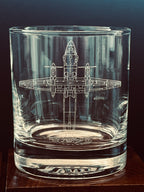 Clear glass tumbler with an engraved antonov an-32 airplane design on a dark background
