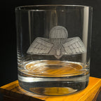 A crystal glass with an engraving of a paratrooper insignia