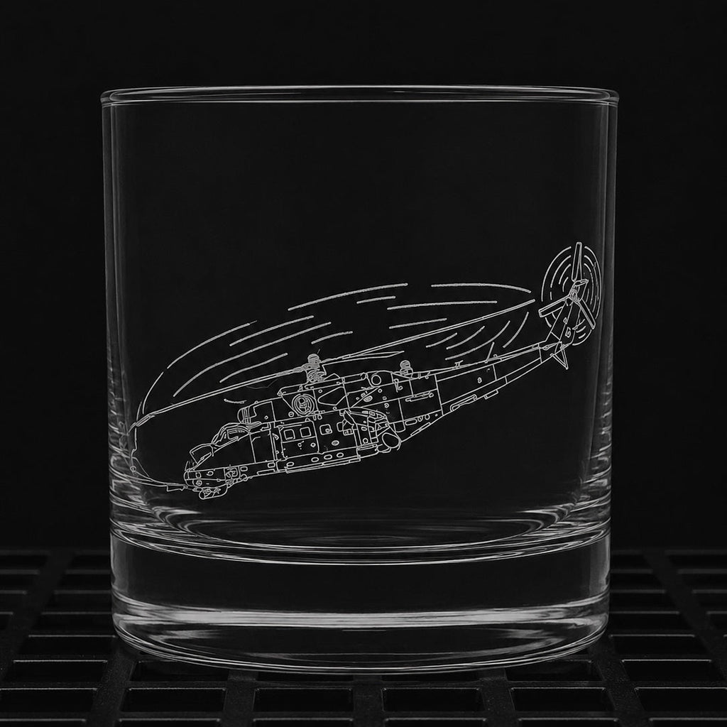 A clear glass rocks tumbler with an etched line drawing of a Mi-35 attack helicopter, shown against a solid black background.