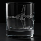 A clear glass rocks tumbler with a white laser-engraved blueprint-style drawing of a Mig-27 fighter jet on the side, shown against a solid black background.