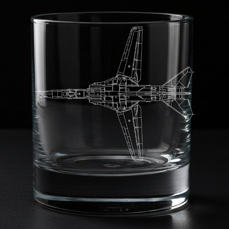 A clear glass rocks tumbler with a white laser-engraved blueprint-style drawing of a Mig-27 fighter jet on the side, shown against a solid black background.