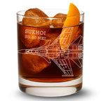 Glass with a Sukhoi SU-30 MKI design, filled with a brown liquid and ice cubes.