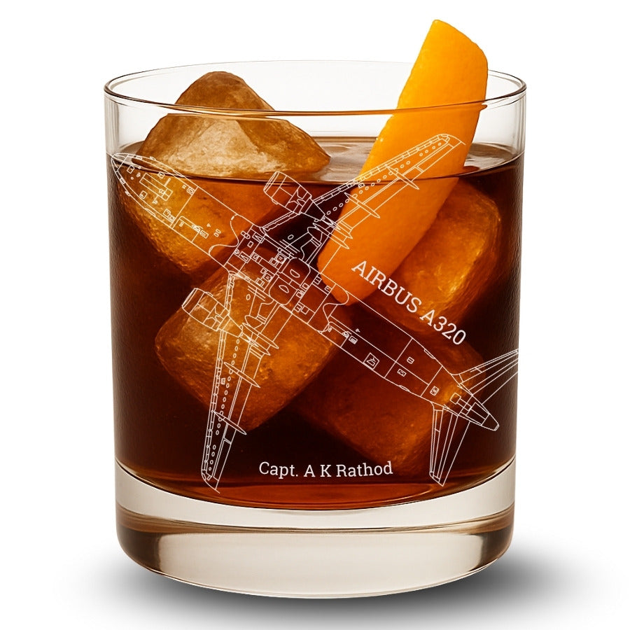 Glass of dark liquid with ice cubes and an orange slice, featuring an Airbus A320 design.