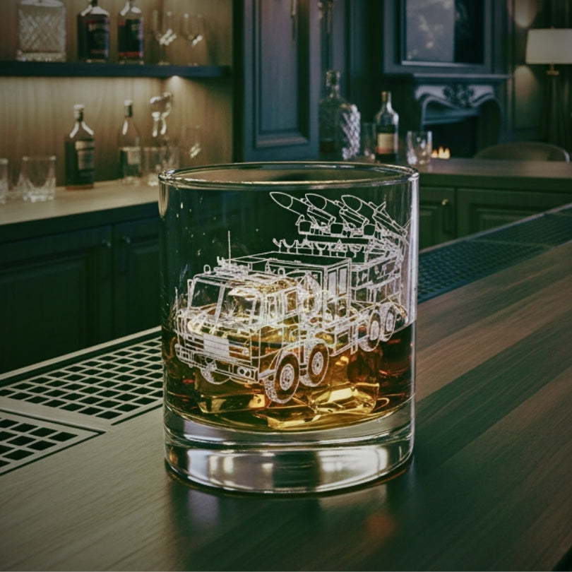 Glass with a akash air defence truck engraving on a bar counter