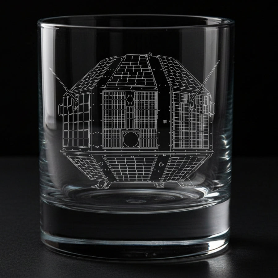 A clear glass rocks tumbler with an etched white line drawing of india's first satellite - the aryabhata from ISRO