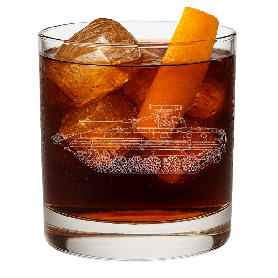 Glass of dark liquid with ice and an orange peel, featuring a bmp-2 tank design on the glass.