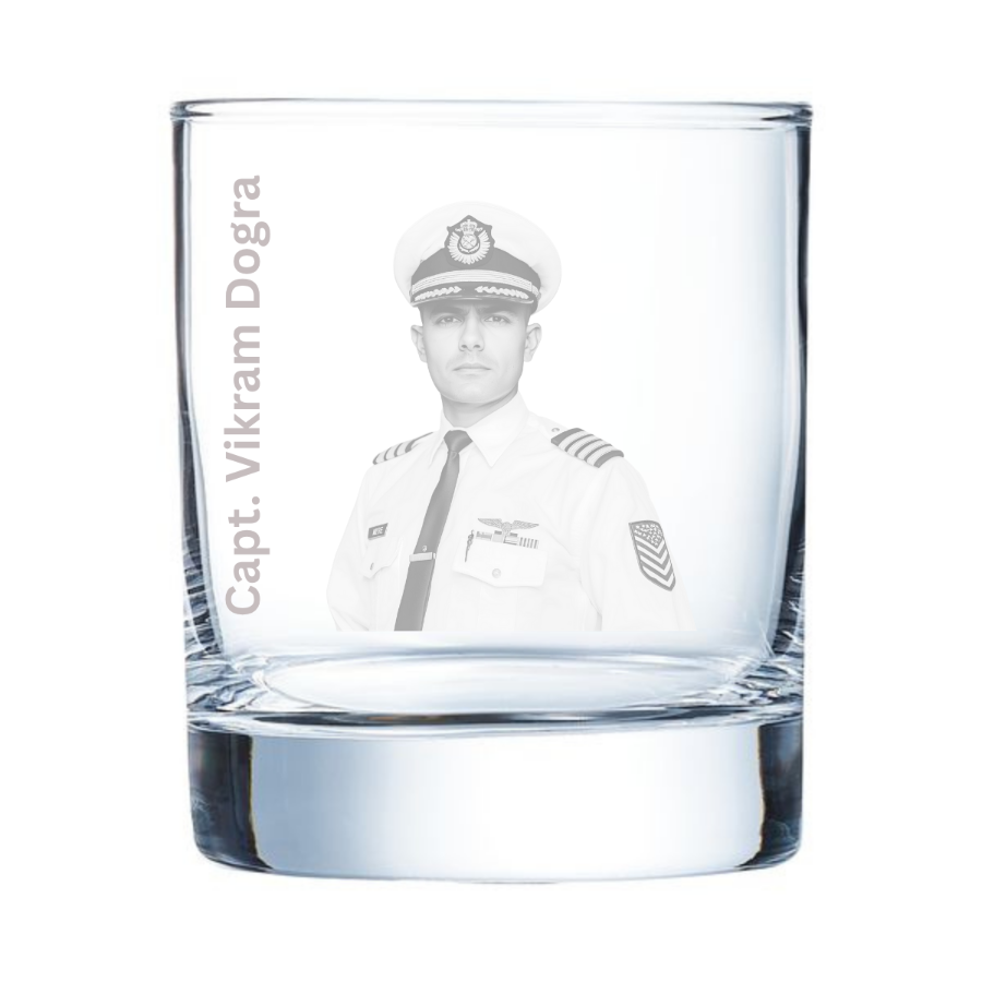Clear glass with engraved portrait and text of a person in uniform on a white background
