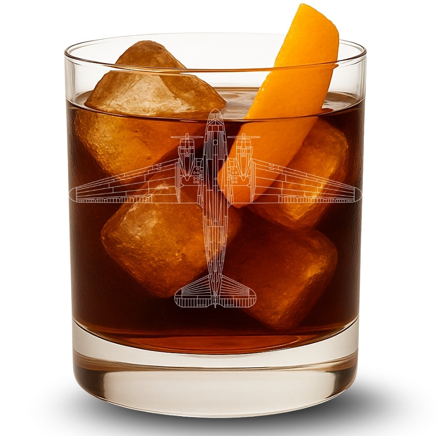 Glass of brown liquid with ice cubes and a DC-3 Dakota airplane design, on a white background