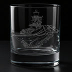 Clear glass tumbler with an engraved aircraft carrier ship INS Vikramaditya design on a black background