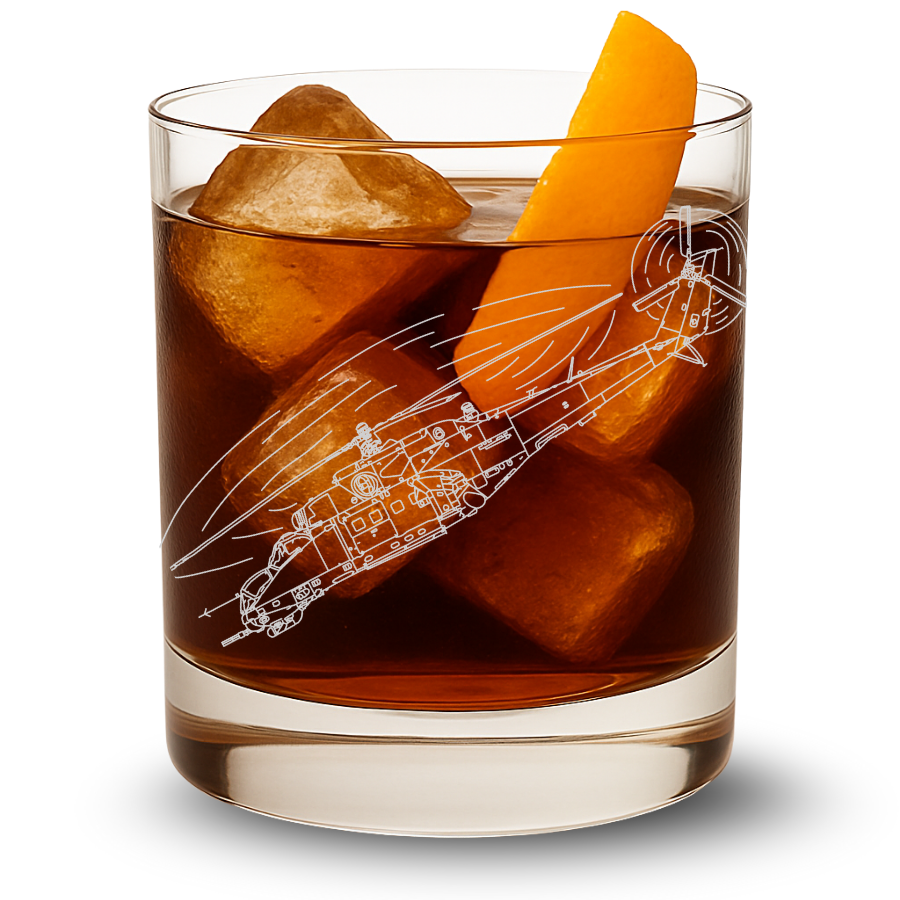 Glass of whiskey with ice cubes and an orange slice, featuring a mi-35 helicopter design on the glass.