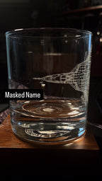 whiskey glass with an etched su-57 on a rotating table